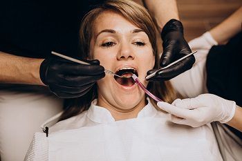 Gingivoplasty treat a gummy smile