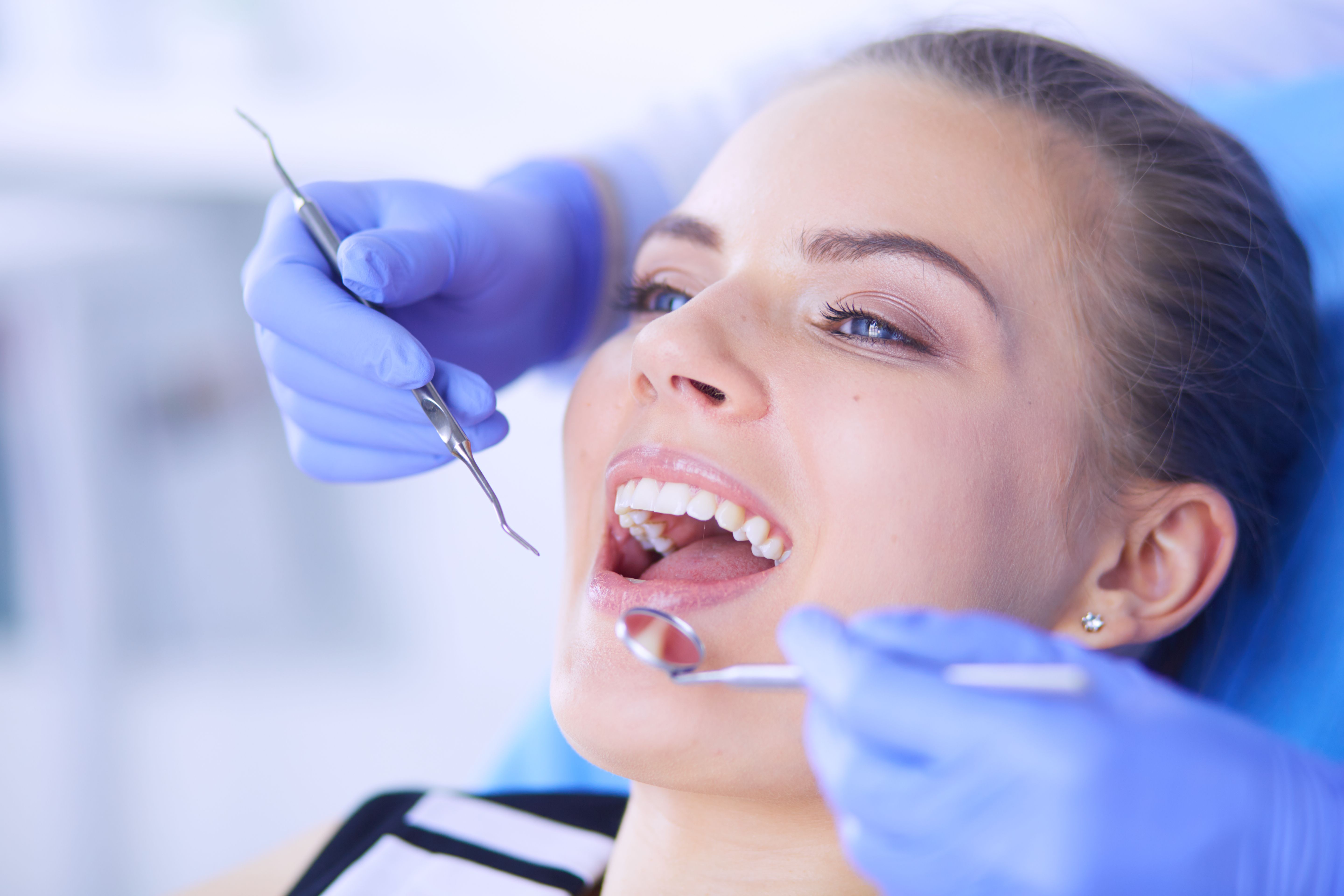 young-female-patient-with-open-mouth-examining-dental-inspection-dentist-office.jpg